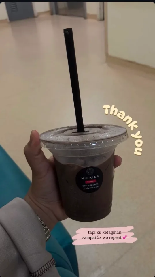 Customer holding a Nickies iced chocolate indoors, with a note saying they are hooked after five repeat orders